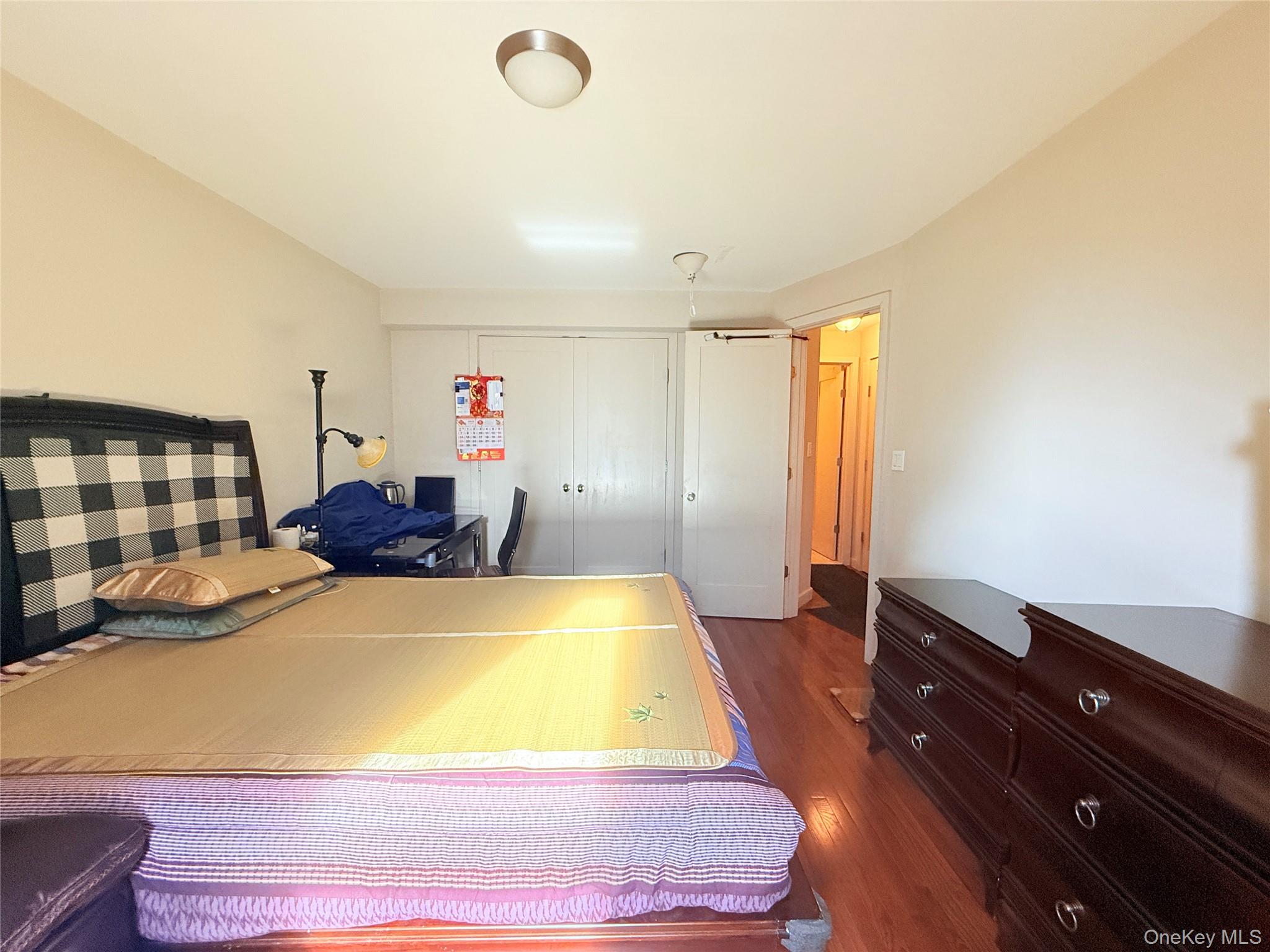87-10 51st Avenue, Unit 5H Queens, NY 11373 - Photo 6 of 16 a room with wooden floor and furniture