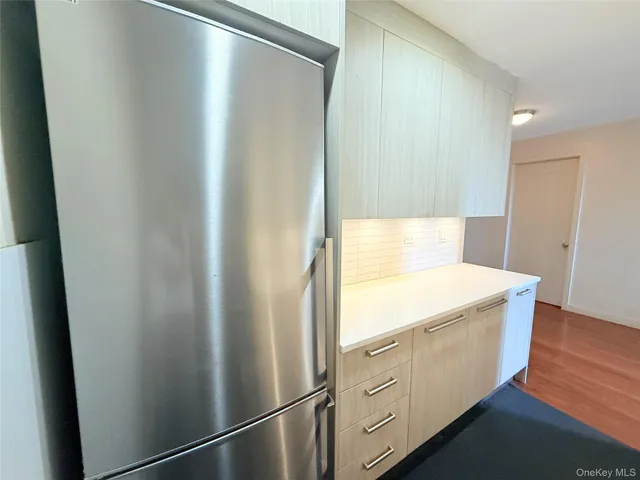 a view of a kitchen with white cabinets