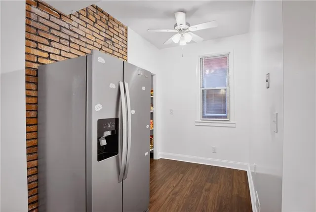 a view of a hallway with a dining room and wooden floor