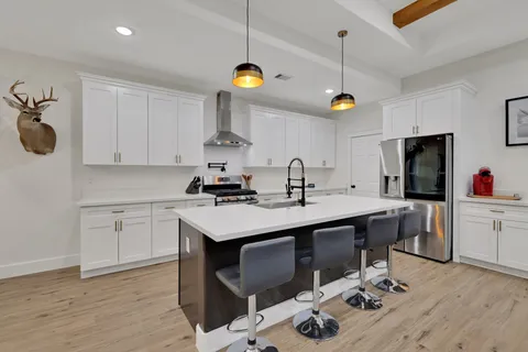 a kitchen with a sink appliances and cabinets
