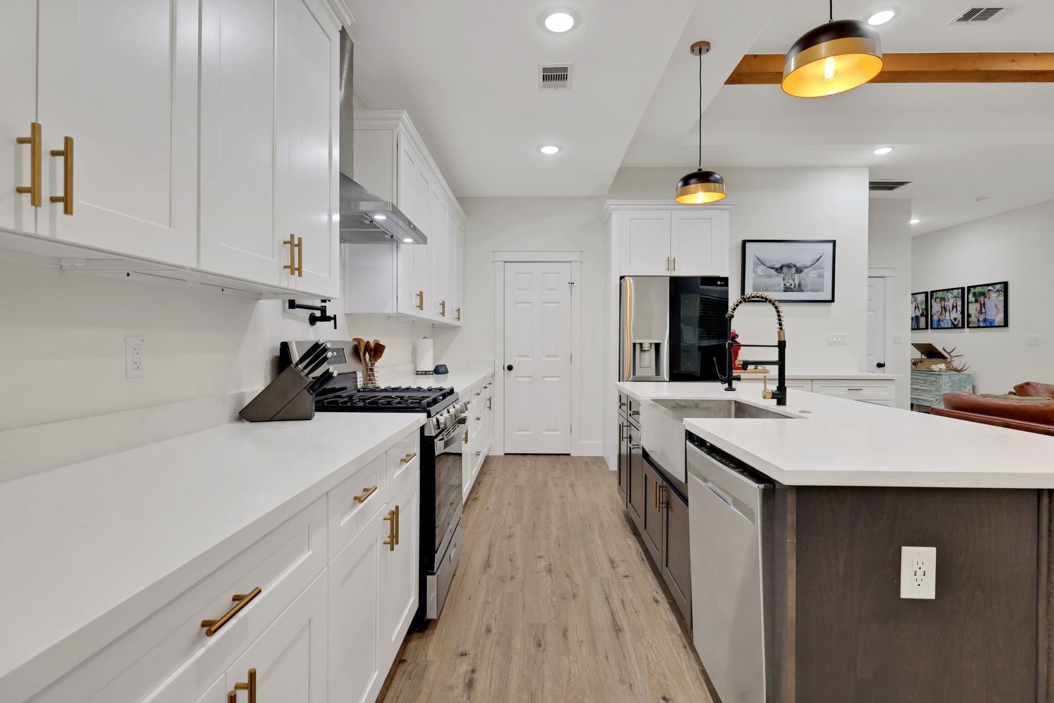 60 V Allen Lane Coldspring, TX 77331 - Photo 10 of 27 a kitchen with stainless steel appliances a sink a stove top oven a counter space and cabinets