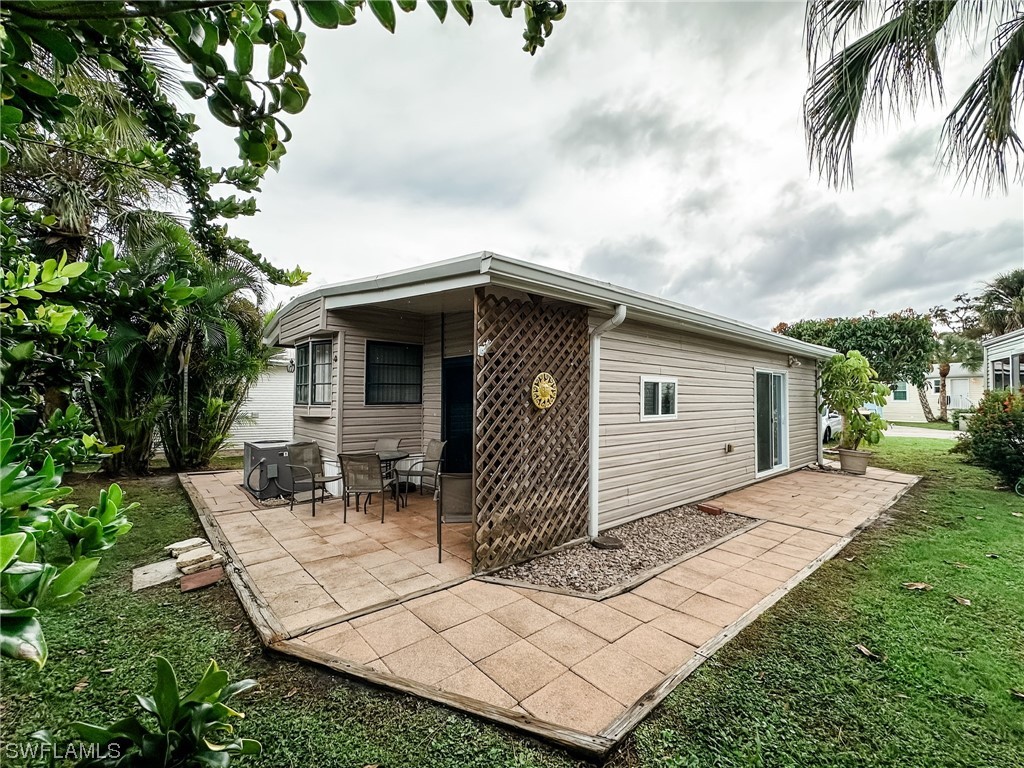 10849 Barred Owl Circle, Unit 25 Estero, FL 33928 - Photo 21 of 24 a front view of a house with garden