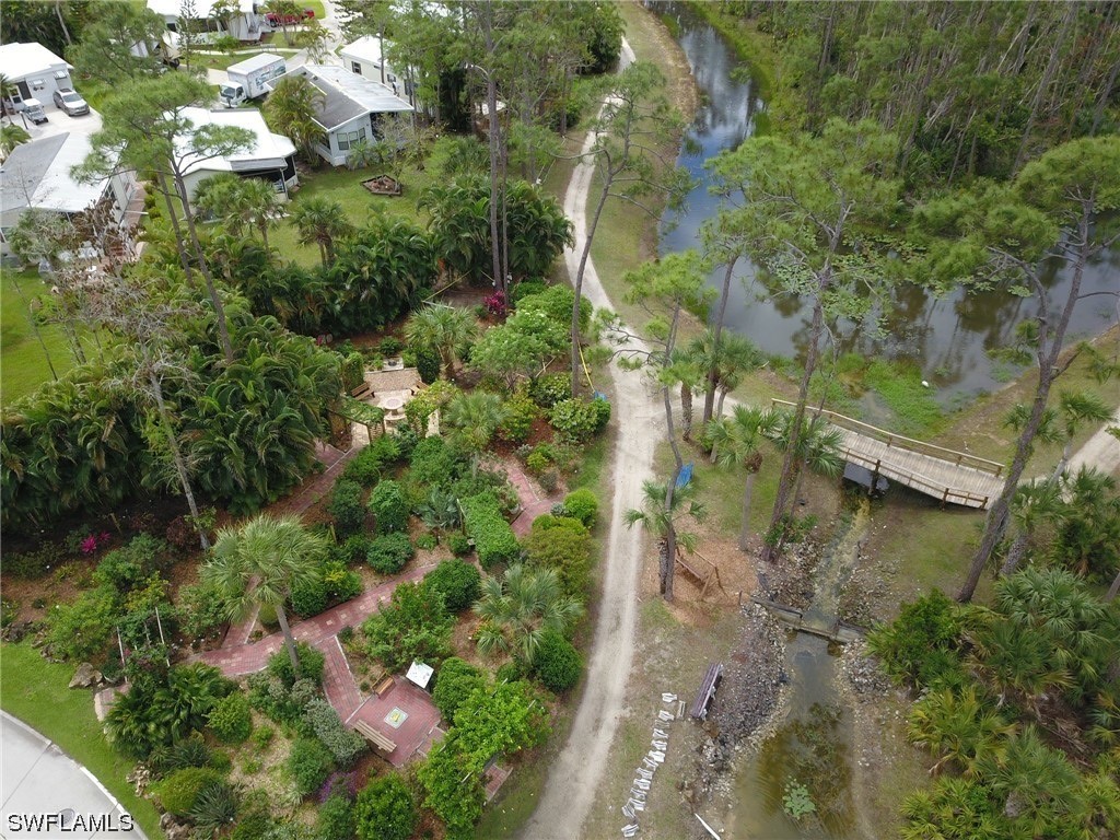 10849 Barred Owl Circle, Unit 25 Estero, FL 33928 - Photo 23 of 24 an aerial view of residential house with outdoor space and trees all around