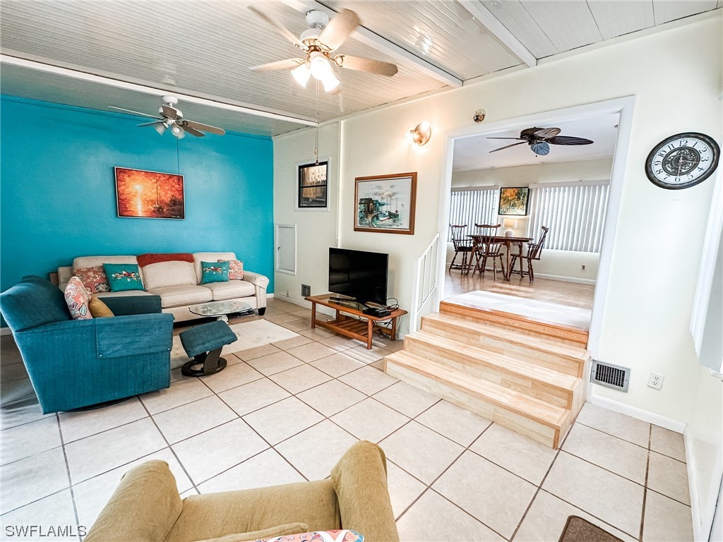 10849 Barred Owl Circle, Unit 25 Estero, FL 33928 - Photo 6 of 24 a living room with furniture and a fireplace