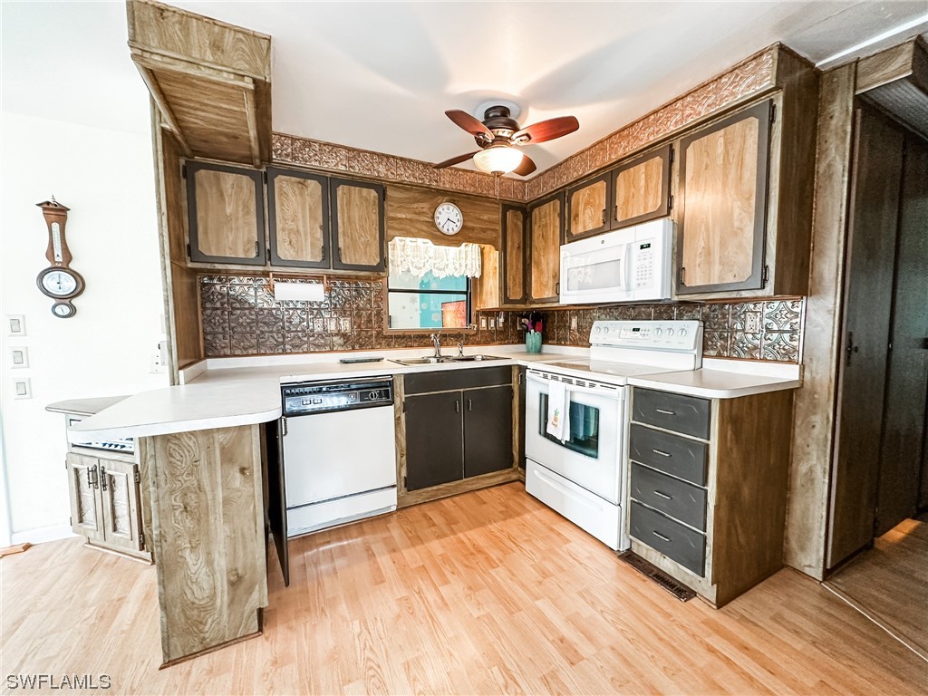 10849 Barred Owl Circle, Unit 25 Estero, FL 33928 - Photo 10 of 24 a kitchen with a stove top oven sink and a window