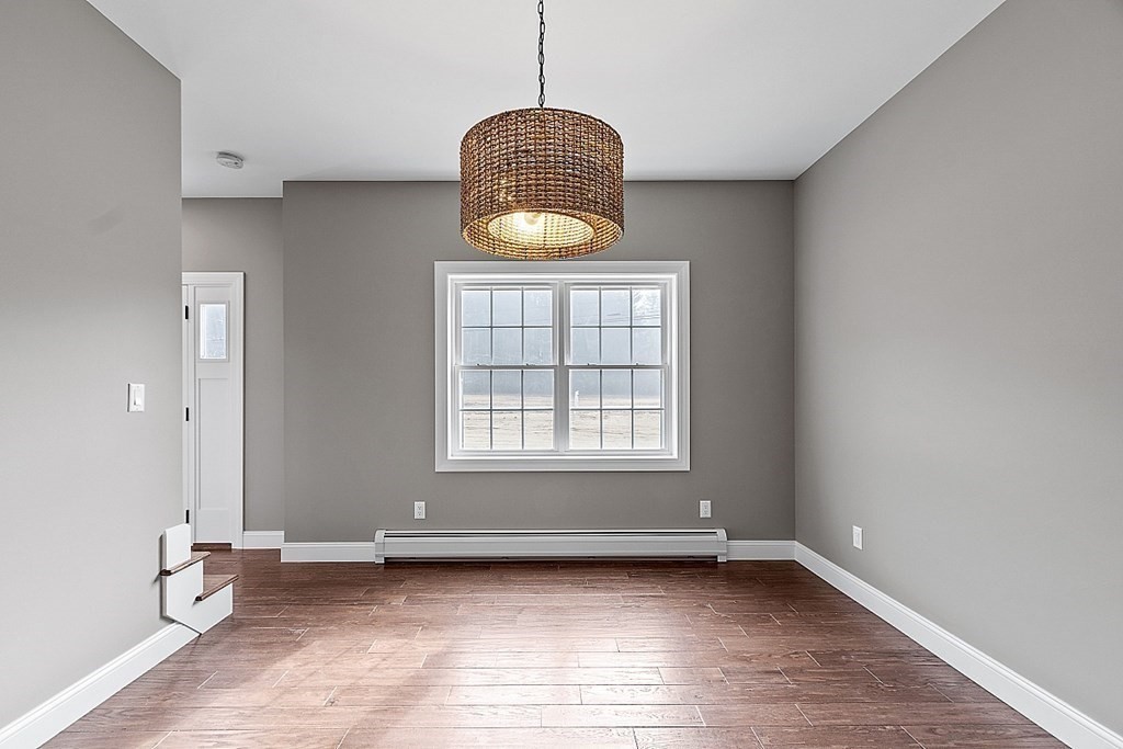 1435 South Athol Road Athol, MA 01331 - Photo 13 of 23 a view of an empty room with window and wooden floor