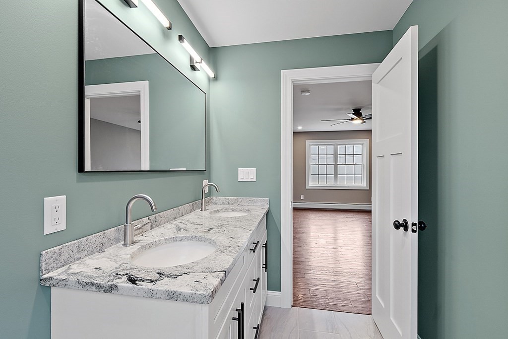 1435 South Athol Road Athol, MA 01331 - Photo 22 of 23 a en suite bathroom with a granite countertop sink and a mirror