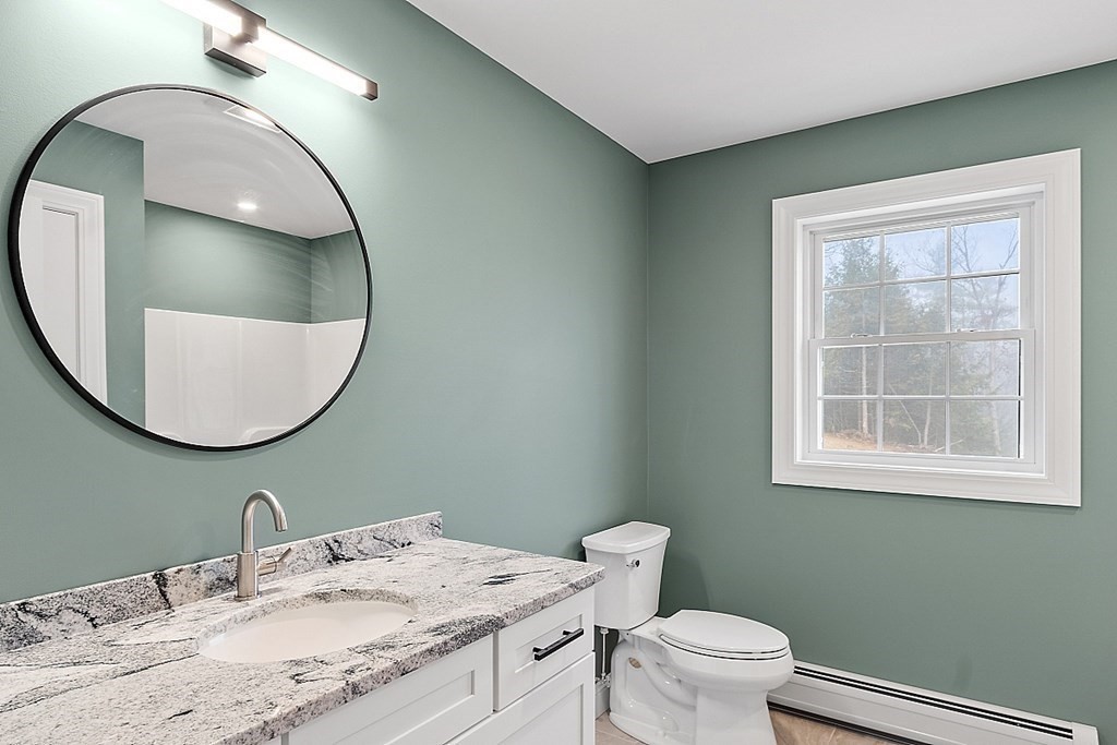 1435 South Athol Road Athol, MA 01331 - Photo 23 of 23 a bathroom with a granite countertop toilet a sink and mirror