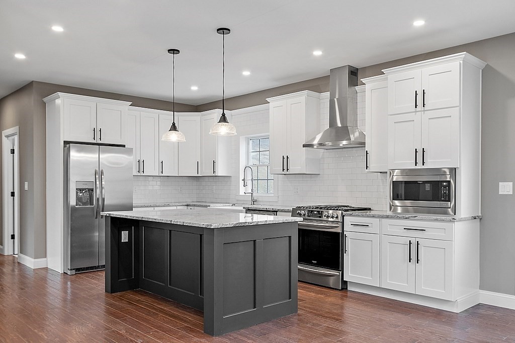 1435 South Athol Road Athol, MA 01331 - Photo 6 of 23 a kitchen with stainless steel appliances granite countertop a sink a stove a refrigerator and island with wooden floor