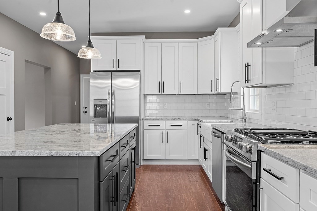 1435 South Athol Road Athol, MA 01331 - Photo 7 of 23 a kitchen with stainless steel appliances granite countertop a sink stove a refrigerator and white cabinets with wooden floor