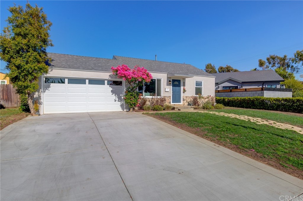 8218 Handley Avenue Los Angeles, CA 90045 - Photo 1 of 20 a front view of a house with a yard and a garage
