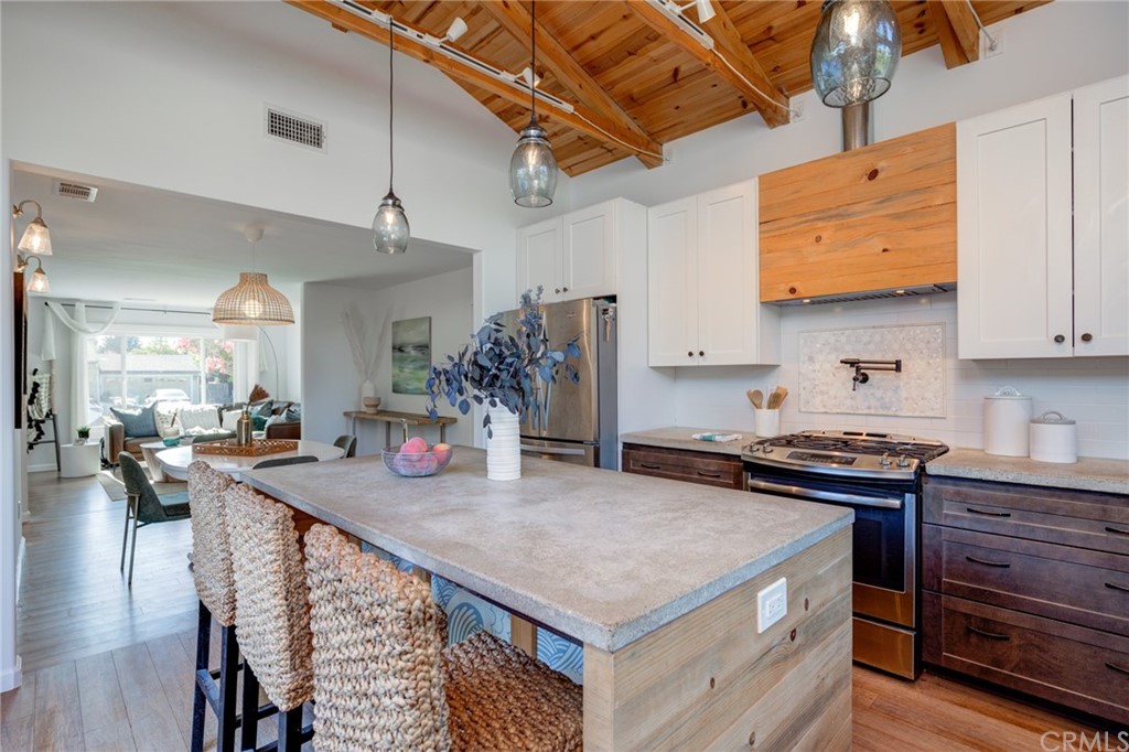 8218 Handley Avenue Los Angeles, CA 90045 - Photo 3 of 20 a kitchen with stainless steel appliances granite countertop a stove a sink dishwasher and cabinets with wooden floor
