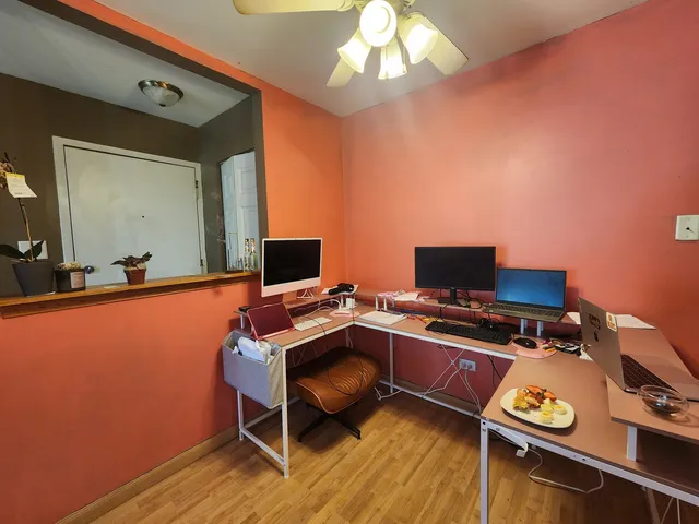 a bedroom with a bed and a desk