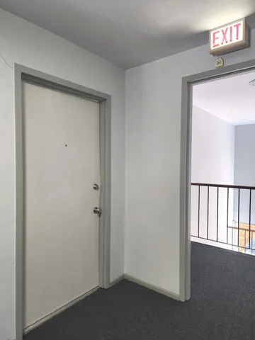 a view of a workspace with furniture and a kitchen