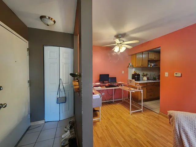 a kitchen with a refrigerator and cabinets