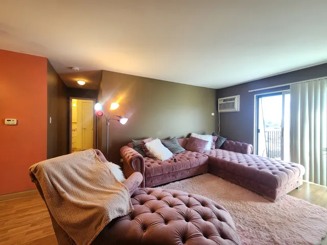 a spacious bedroom with a bed and glass wall