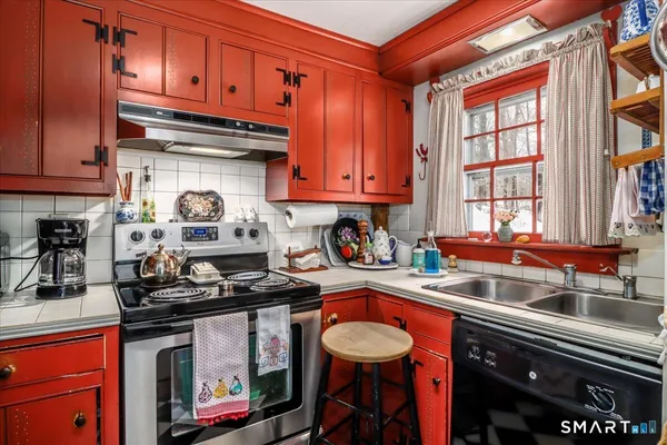 a kitchen with stainless steel appliances granite countertop a stove sink and cabinets