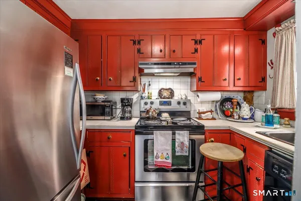 a kitchen with stainless steel appliances granite countertop a stove and cabinets