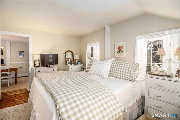 a bedroom with a bed and a table with chair