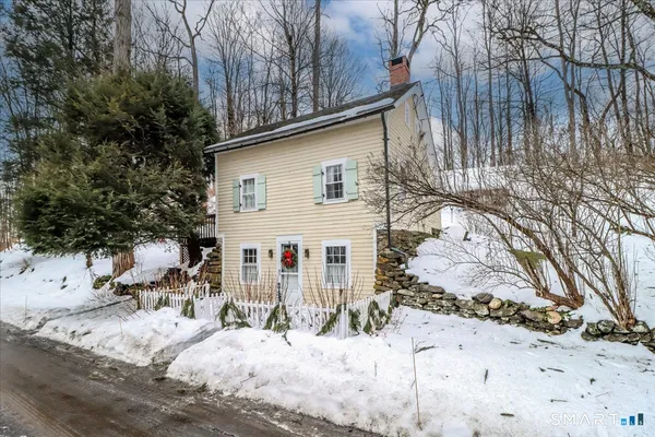 a view of a house with snow on the background