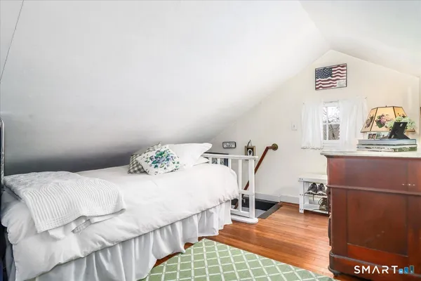 a bedroom with a bed window and a table