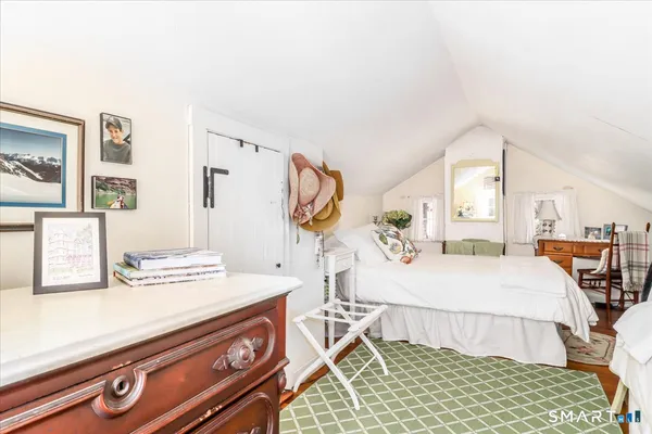 a bedroom with a bed dresser and a window