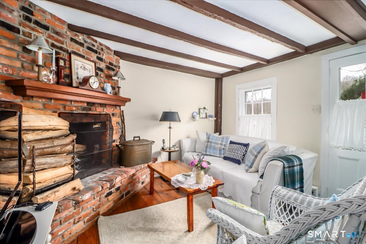 3 Gelston Road Sherman, CT 06784 - Photo 28 of 36 a living room with furniture a fireplace and a flat screen tv