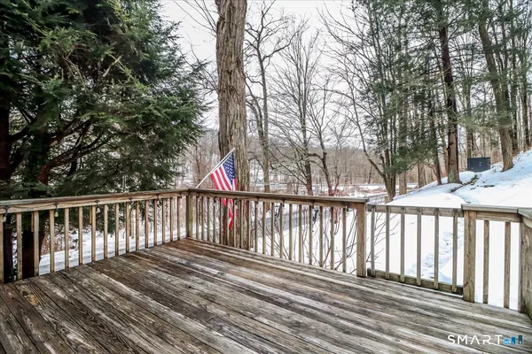 a balcony with wooden floor and fence