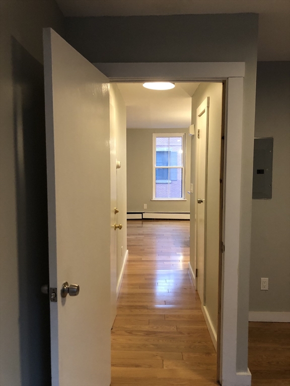 24 Bradford Street, Unit 2 Boston, MA 02118 - Photo 13 of 16 a view of a hallway with wooden floor and closet area