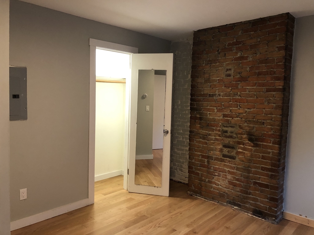24 Bradford Street, Unit 2 Boston, MA 02118 - Photo 8 of 16 an empty room with wooden floor and a window