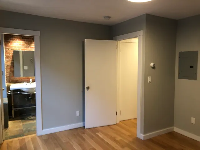 a view of an empty room and bathroom