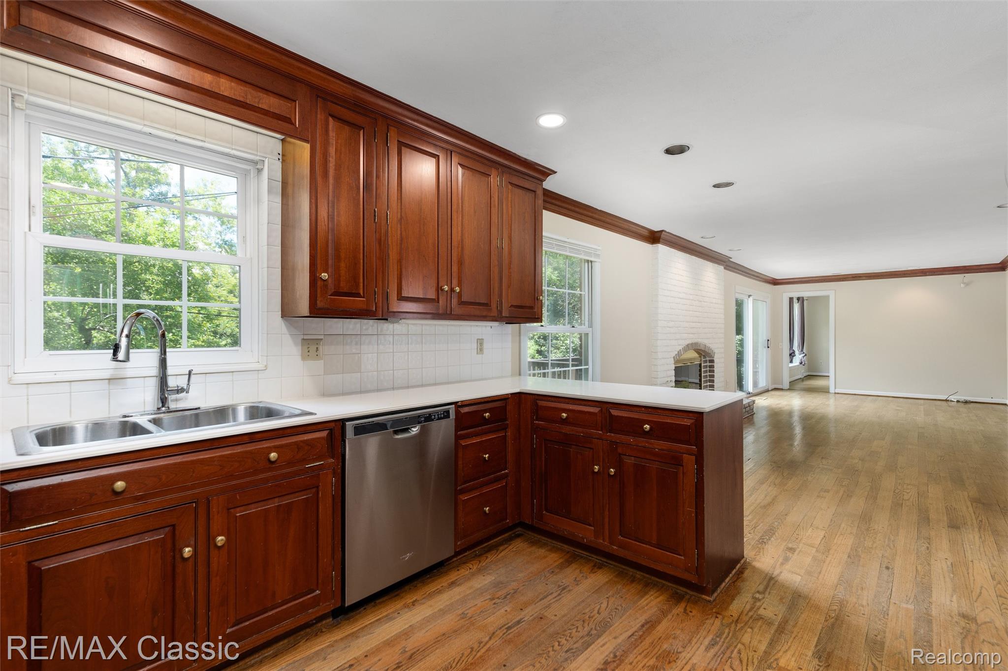 4268 Covered Bridge Road Bloomfield Hills, MI 48302 - Photo 3 of 35 Kitchen featuring wood-finish cabinetry, stainless steel double basin sink, and a stainless steel dishwasher