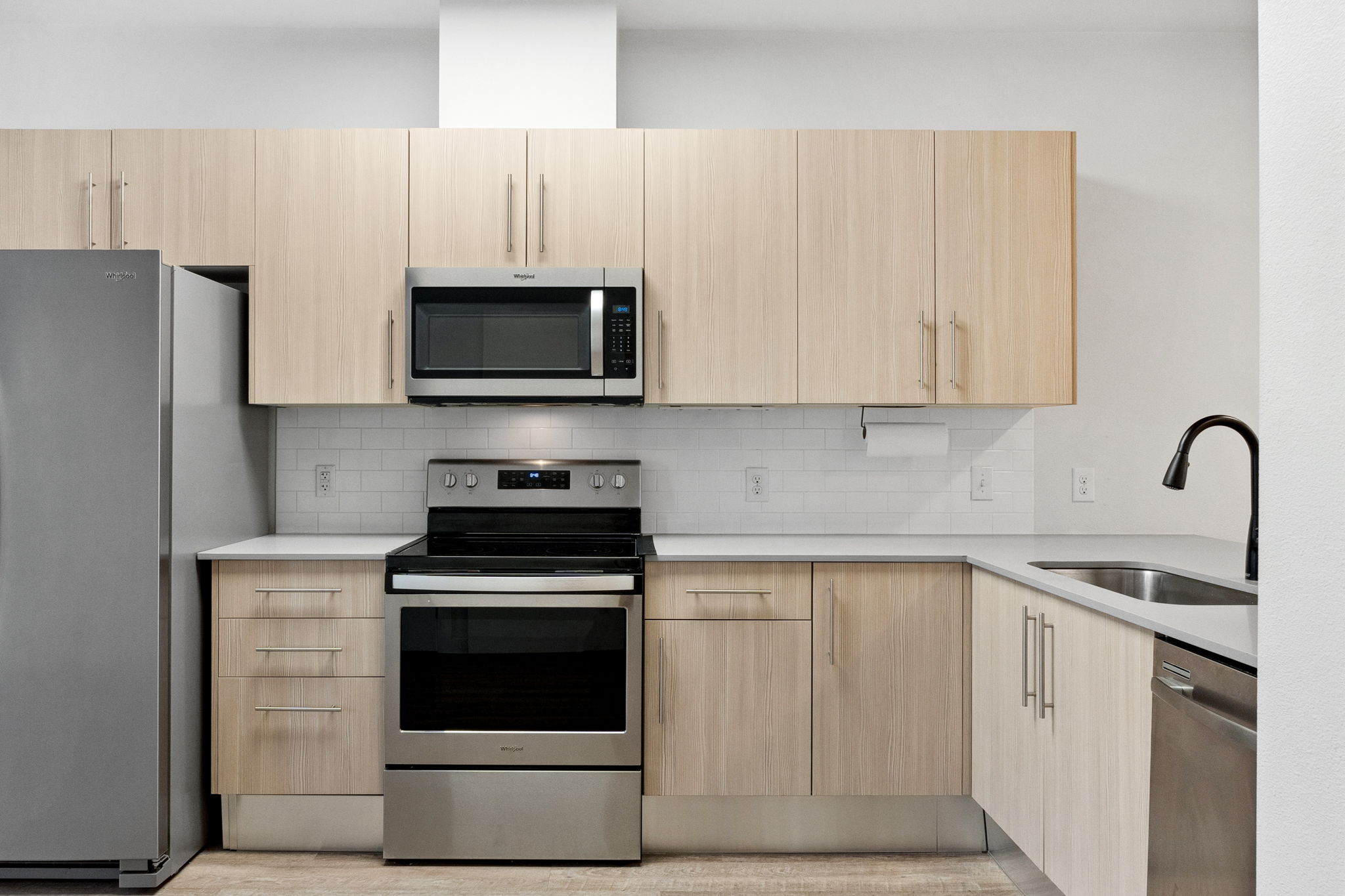 7805 Cooper Lane, Unit 606 Austin, TX 78745 - Photo 9 of 35 a kitchen with cabinets stainless steel appliances and a sink