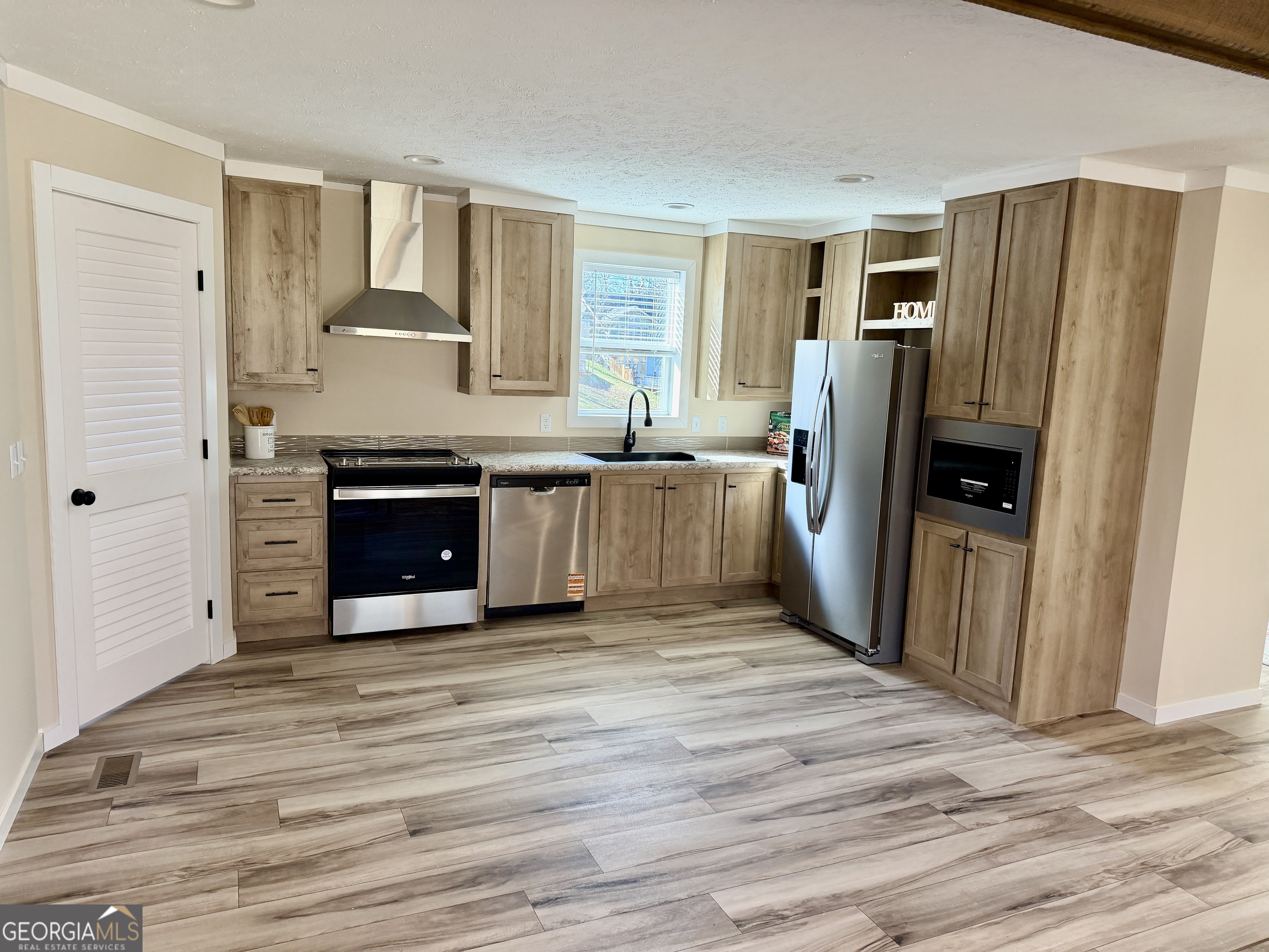 433 B C Grant Road Alto, GA 30510 - Photo 9 of 23 a view of a kitchen with fridge and wooden floor