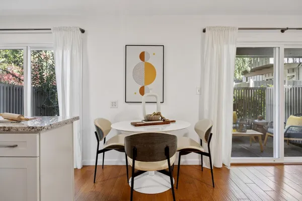 a view of a dining room with furniture window and wooden floor