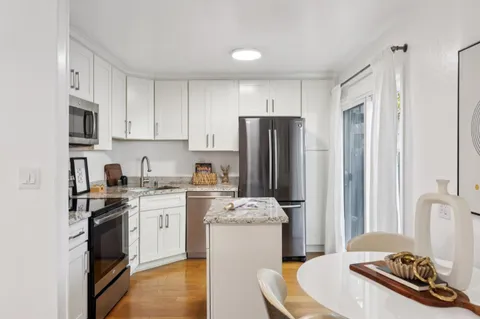 a kitchen with a refrigerator stove and sink