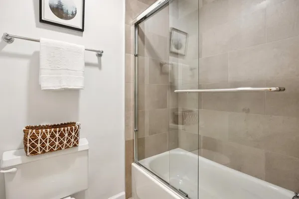a bathroom with a bathtub and shower