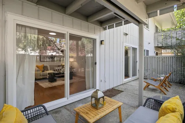 a living room with furniture and a floor to ceiling window