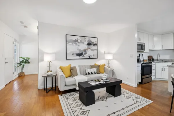 a living room with furniture and wooden floor