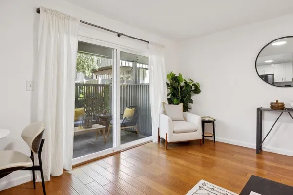 a living room with furniture and a potted plant
