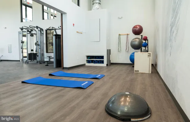 a front view of a building with glass windows and lake view