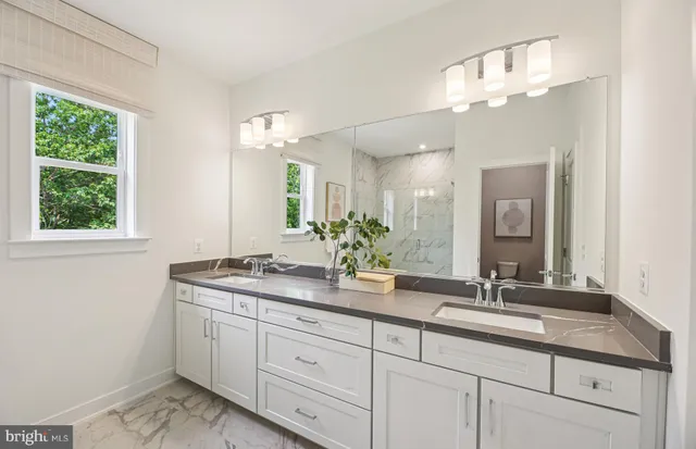 a bathroom with a double vanity sink and a mirror
