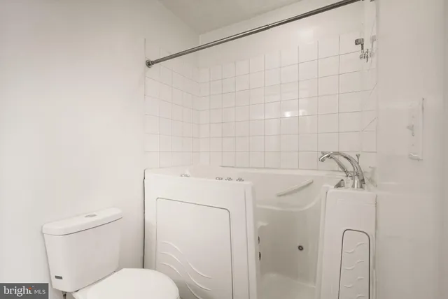 a bathroom with a toilet sink and vanity