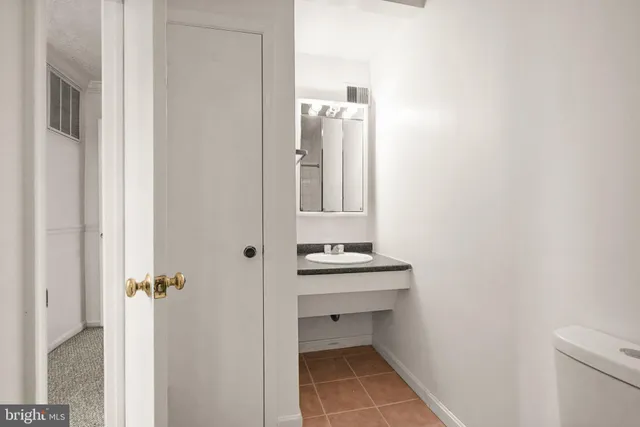 a kitchen with a refrigerator and a sink