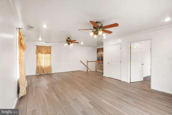 a view of a livingroom with a ceiling fan and window
