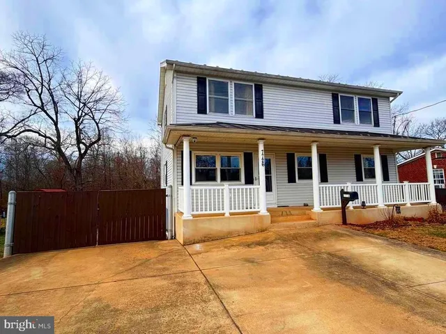 a view of a livingroom with wooden floor and a ceiling fan