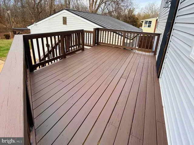 a view of a porch with wooden floor and stairs