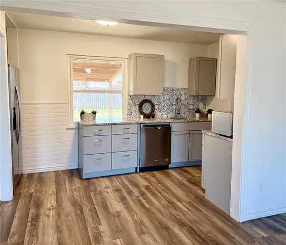 a kitchen with a sink and a stove top oven