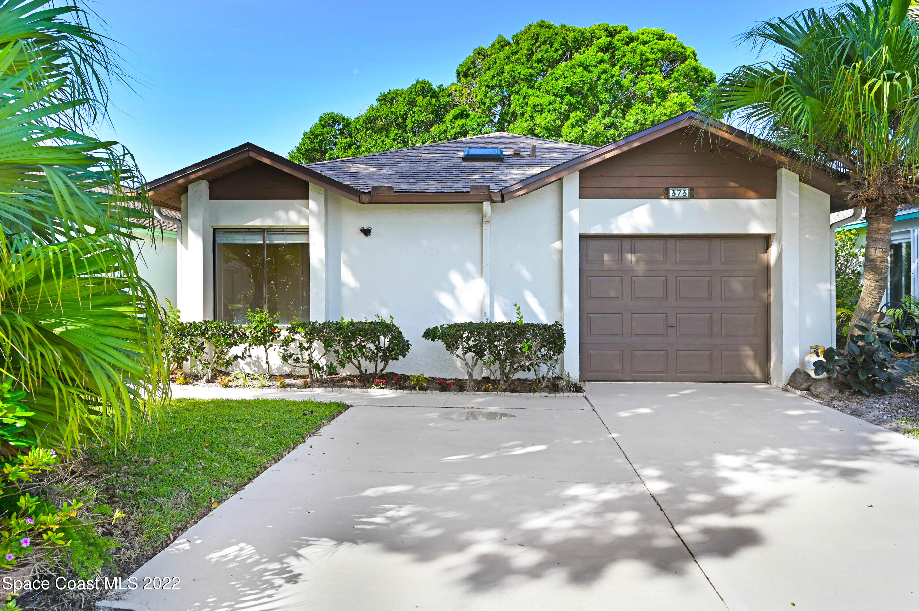 373 Myrtlewood Road Melbourne, FL 32940 - Photo 11 of 42 a front view of a house with a yard and garage