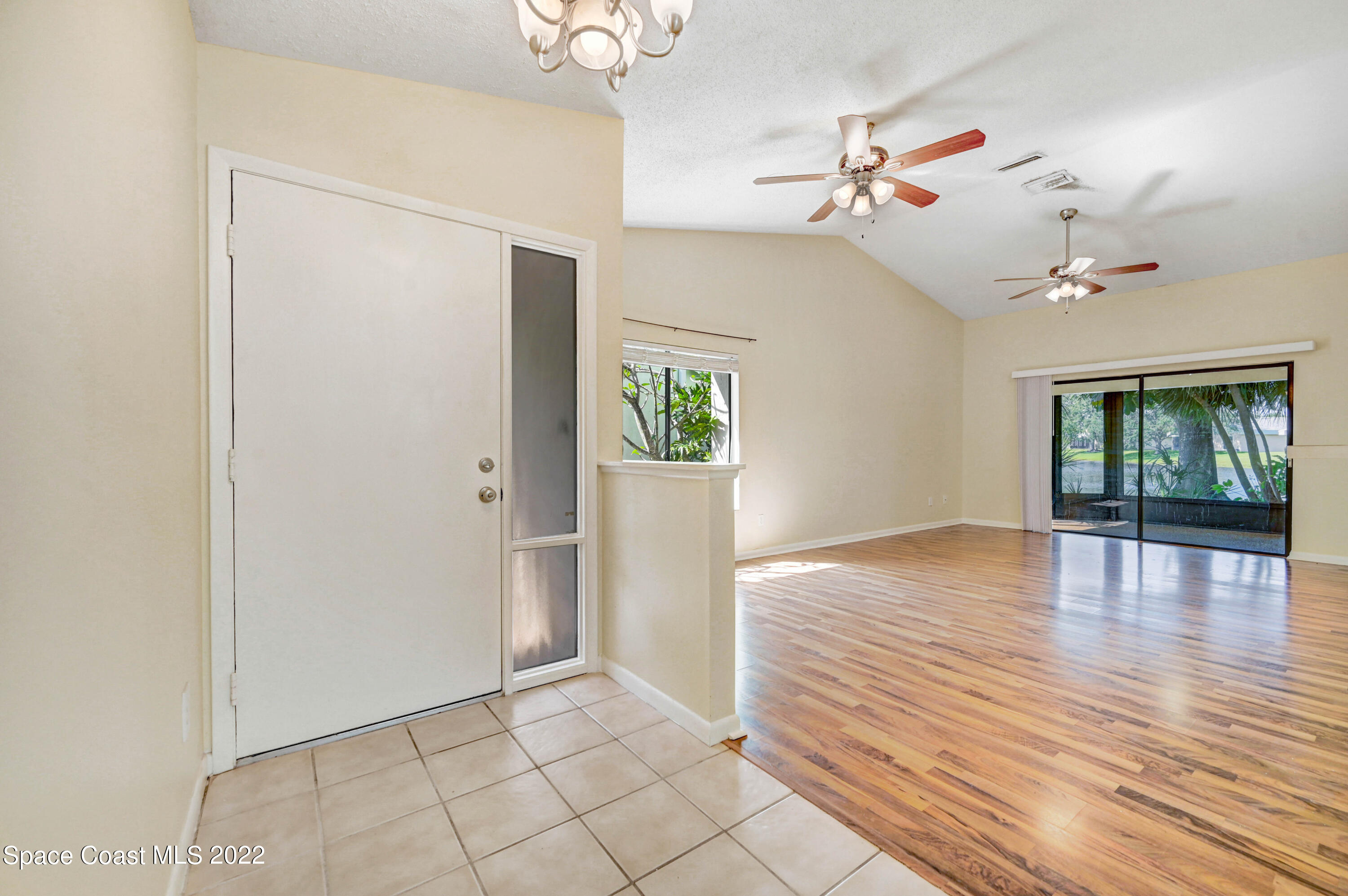 373 Myrtlewood Road Melbourne, FL 32940 - Photo 13 of 42 wooden floor in an empty room with a window